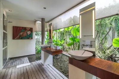 a bathroom with two sinks and a large window at Stunning 4 Bed, Butler Service, Security, Central in Seminyak