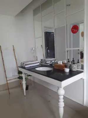 a bathroom with a sink and a large mirror at Rove One-bedroom Pool Villa Seminyak in Seminyak