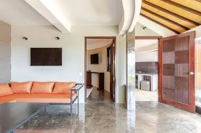 a living room with a couch and a kitchen at Sunset view apartment in Nusa Dua in Nusa Dua