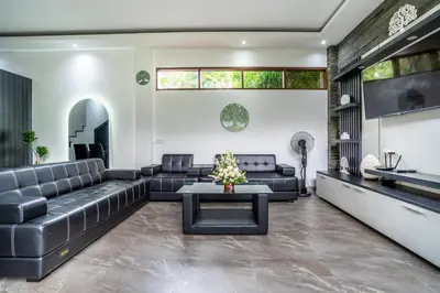 a living room with a couch and a table at Villa Liamax by JB villas in Seminyak