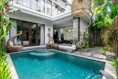 a swimming pool in the middle of a house at Villa Liamax by JB villas in Seminyak