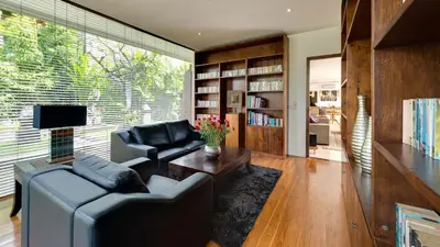 a living room with a couch and a table at Villa Aiko in Jimbaran