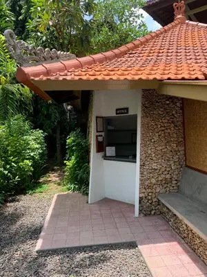 a building with a microwave on the side of it at Poppies Cottages on Two in Legian