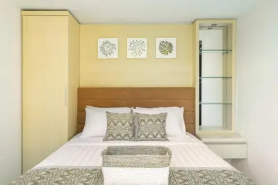 a bedroom with a bed with white sheets and pillows at Villa De Luca By Aishwarya International in Umalas