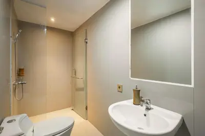 a bathroom with a sink and a toilet and a mirror at Villa De Luca By Aishwarya International in Umalas