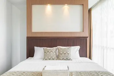 a bedroom with a bed with a framed picture at Villa De Luca By Aishwarya International in Umalas