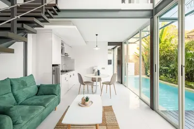 a living room with a green couch and a table at Villa De Luca By Aishwarya International in Umalas