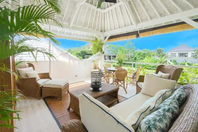 a living room with furniture and a view of the ocean at Casa Elias Seminyak in Seminyak