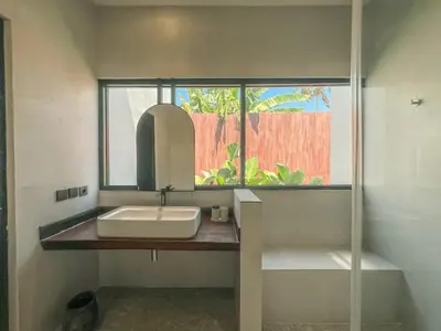 a bathroom with a sink and a mirror at Cara Villa Bali in Seminyak