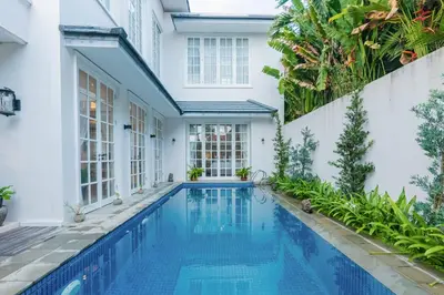 a swimming pool in the backyard of a house at Viki Nest by SooBali 4BR in Umalas