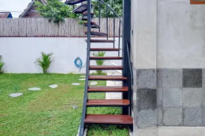 a spiral staircase leading up to a house at Wakajima House Kerobokan by The Lavana in Kerobokan