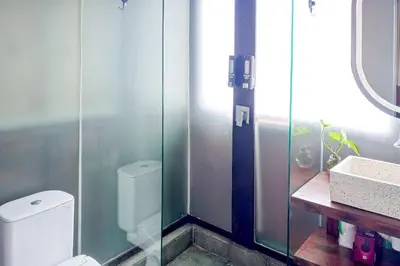 a bathroom with a toilet and a sink at Wakajima House Kerobokan by The Lavana in Kerobokan