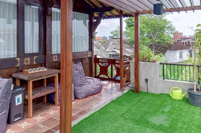 a screened in porch with green grass on a balcony at Wakajima House Kerobokan by The Lavana in Kerobokan