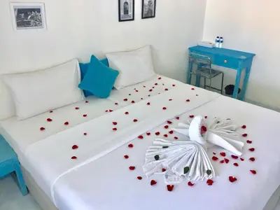 a white bed with red hearts on it at Paras Paros Marina Lodge in Sanur
