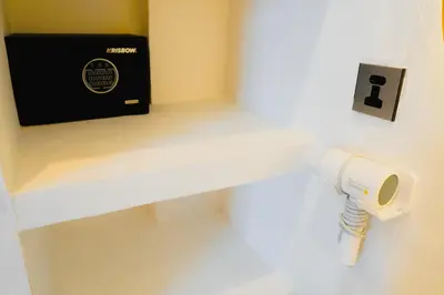 a security camera on a wall next to a box at La Rylin Villa in Kuta