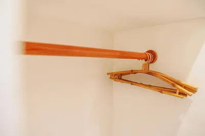 a wooden shelf on the corner of a room at La Rylin Villa in Kuta