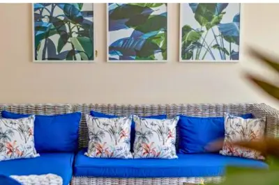 a blue couch with pillows in a living room at Omkara 2 BR Deluxe Private Pool Villa ZN253 in Seminyak