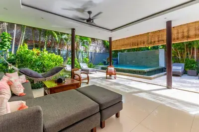 a living room with a hammock and a swimming pool at Omkara 2 BR Deluxe Private Pool Villa ZN253 in Seminyak