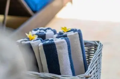 a bunch of blue and white towels in a basket at Omkara 2 BR Deluxe Private Pool Villa ZN253 in Seminyak