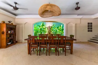 a dining room with a table and a aquarium at Onkita 4 BR Private Pool Villa ZN254 in Seminyak