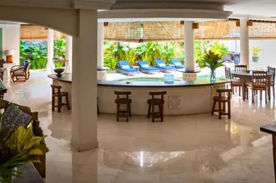 a large lobby with a large table and chairs at Onkita 4 BR Private Pool Villa ZN254 in Seminyak