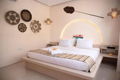 a bedroom with a large bed and clocks on the wall at Villa Umi Paradise Bliss 3BD Villa in Prime Area in Umalas