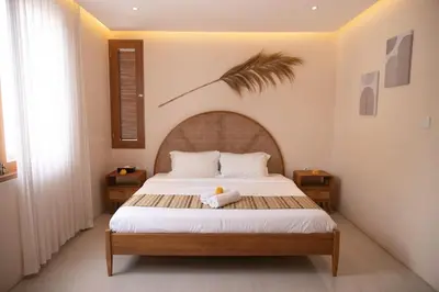 a bedroom with a large bed with a wooden headboard at Villa Umi Paradise Bliss 3BD Villa in Prime Area in Umalas