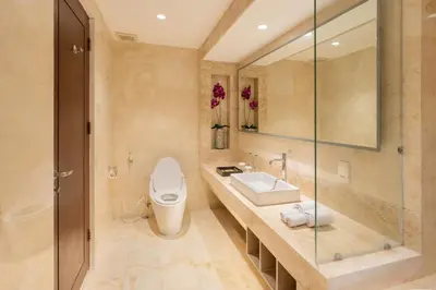 a bathroom with a toilet and a sink at Kuta Angel Hotel in Kuta