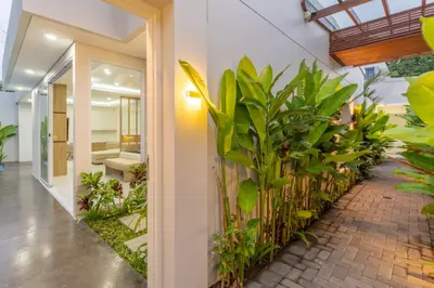 an indoor garden with plants in a hallway at Arunika Prime Villa in Seminyak