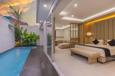 a bedroom with a bed and a swimming pool at Arunika Prime Villa in Seminyak