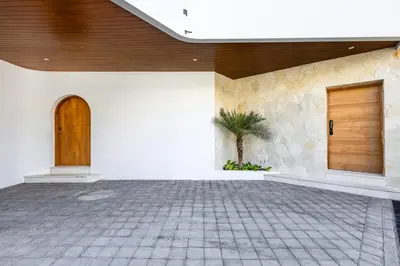 a room with a door and a palm tree in a building at Villa Harper by BaliSuperHost in Canggu