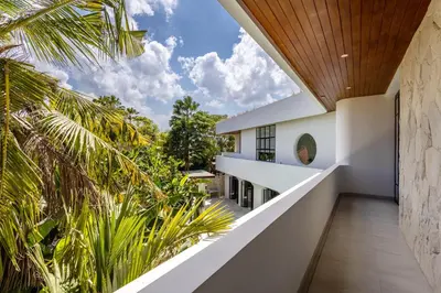a view from the balcony of a house with palm trees at Villa Harper by BaliSuperHost in Canggu