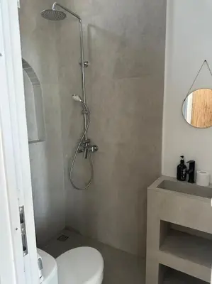 a bathroom with a shower with a toilet and a sink at Villa with pool Nusa Dua in Nusa Dua