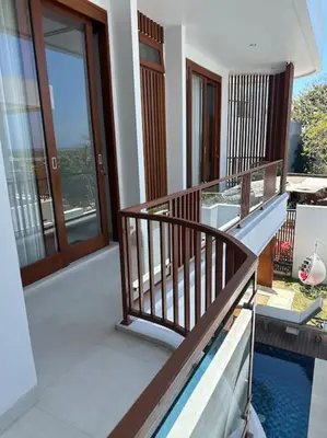 a balcony of a house with a swimming pool at Villa with pool Nusa Dua in Nusa Dua