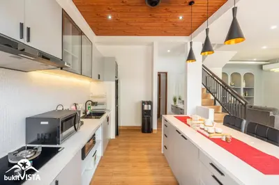 a kitchen with white cabinets and a counter top at Villa Sila by Bukit Vista in Canggu