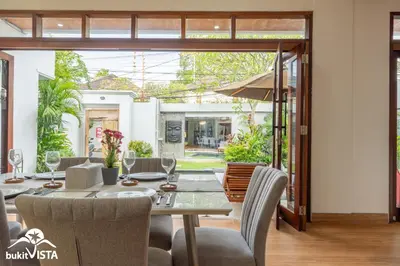 a dining room with a table and chairs at Villa Sila by Bukit Vista in Canggu
