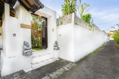 a white building with statues on the side of it at Villa Jasmin Seminyak in Seminyak