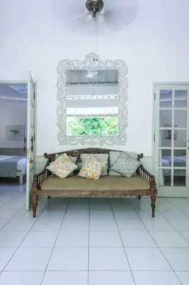 a bench with pillows in a room with a mirror at 2 BedRoom Villa Hideaways Seminyak in Seminyak