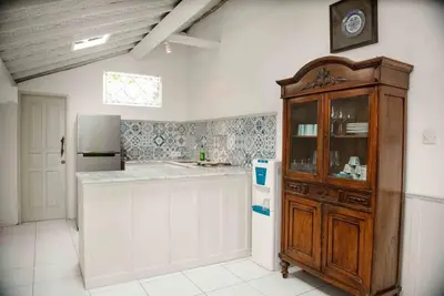 a kitchen with a wooden cabinet and a refrigerator at 2 BedRoom Villa Hideaways Seminyak in Seminyak