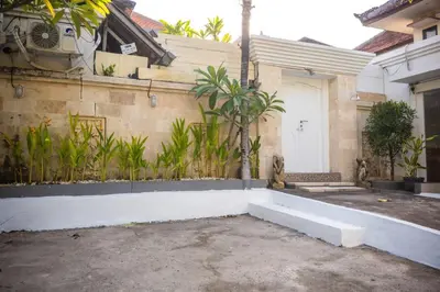 a house with a white door and a fence at Lily Villa in Seminyak