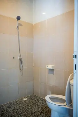 a bathroom with a shower and a toilet at Lily Villa in Seminyak