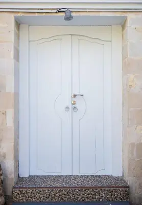 a large white door in a brick building at Lily Villa in Seminyak