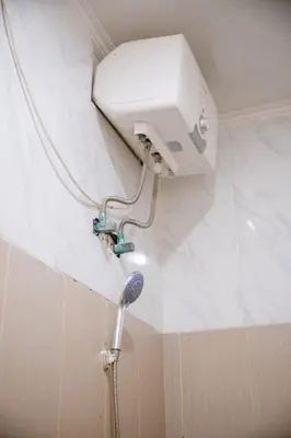 a shower in a bathroom with a shower head at Lily Villa in Seminyak