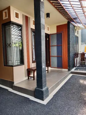 a building with a column and a bench on the porch at Nyoman bali house villa in Seminyak