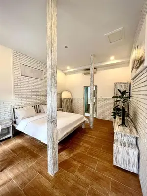 a bedroom with a large bed in a room at Baliview homestay in Umalas