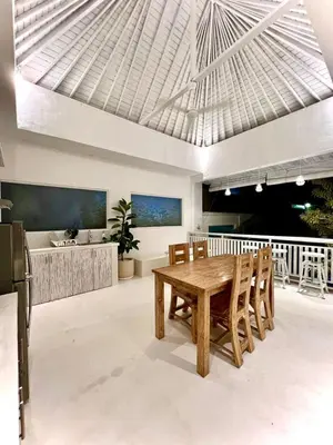 a dining room with a wooden table and chairs at Baliview homestay in Umalas