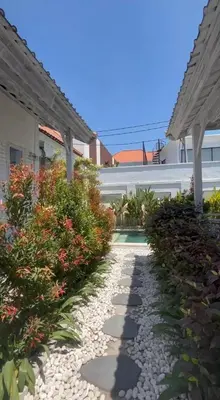 a walkway in front of a house with plants at Baliview homestay in Umalas