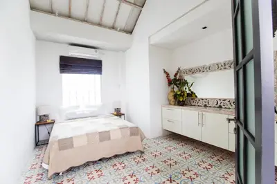 a bedroom with a bed and a window at DUUR Apartments in Seminyak