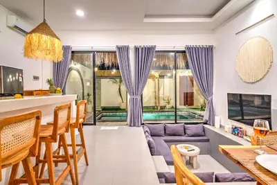 a living room with a couch and a table at Villa Esha III in Seminyak