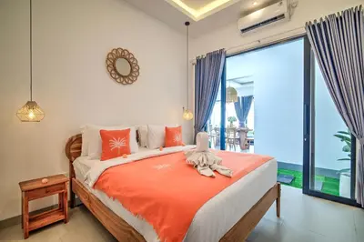 a bedroom with a bed and a large window at Villa Esha III in Seminyak